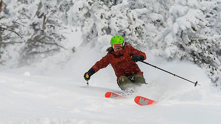 Whiteout, fresh powder conditions as a skier comes down the mountain in the backcountry.