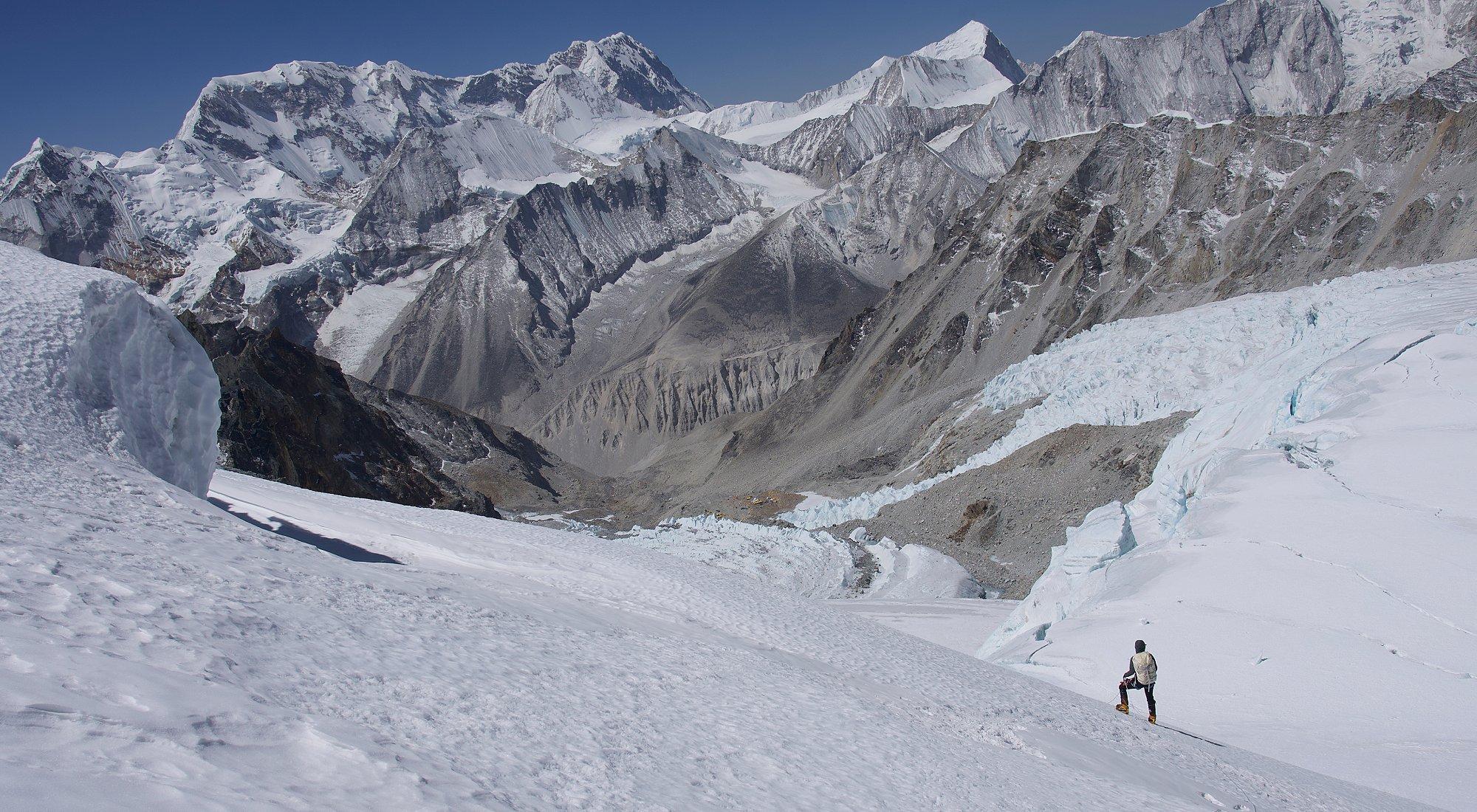 Shayna looking at the Makalu mountain range covered in snow.
