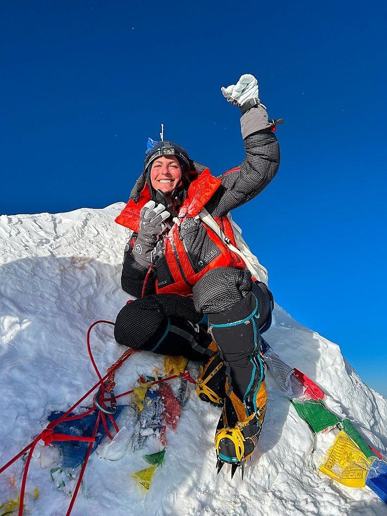 Shayna smiling at the top of Everest.