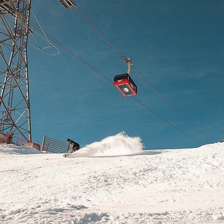 A skier slowing down while on a run