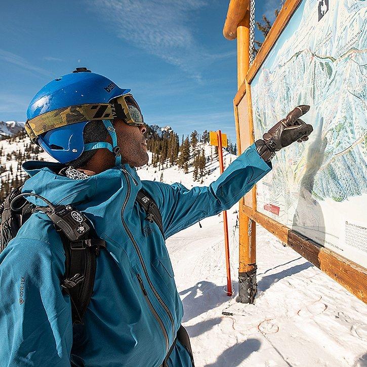 Pointing to the map of the ski resort, looking for good meet up spots