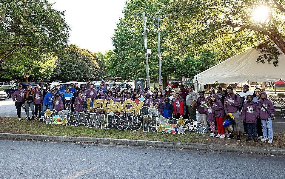 A group of staff, volunteers, and youth pose for the camera during a Greening Youth Foundation Legacy Campout. 