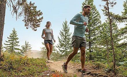 A woman and man running in shoes with TechLite Plush cushioning.