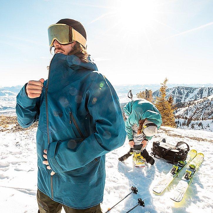 zipping up his jacket and taking in the wind