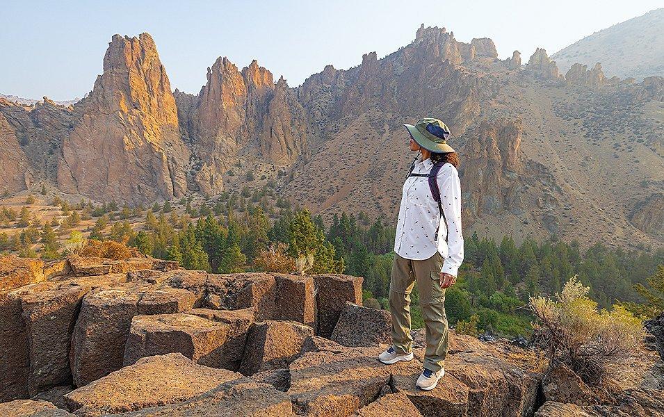 A woman hikes alone in a beautiful high desert landscape. 