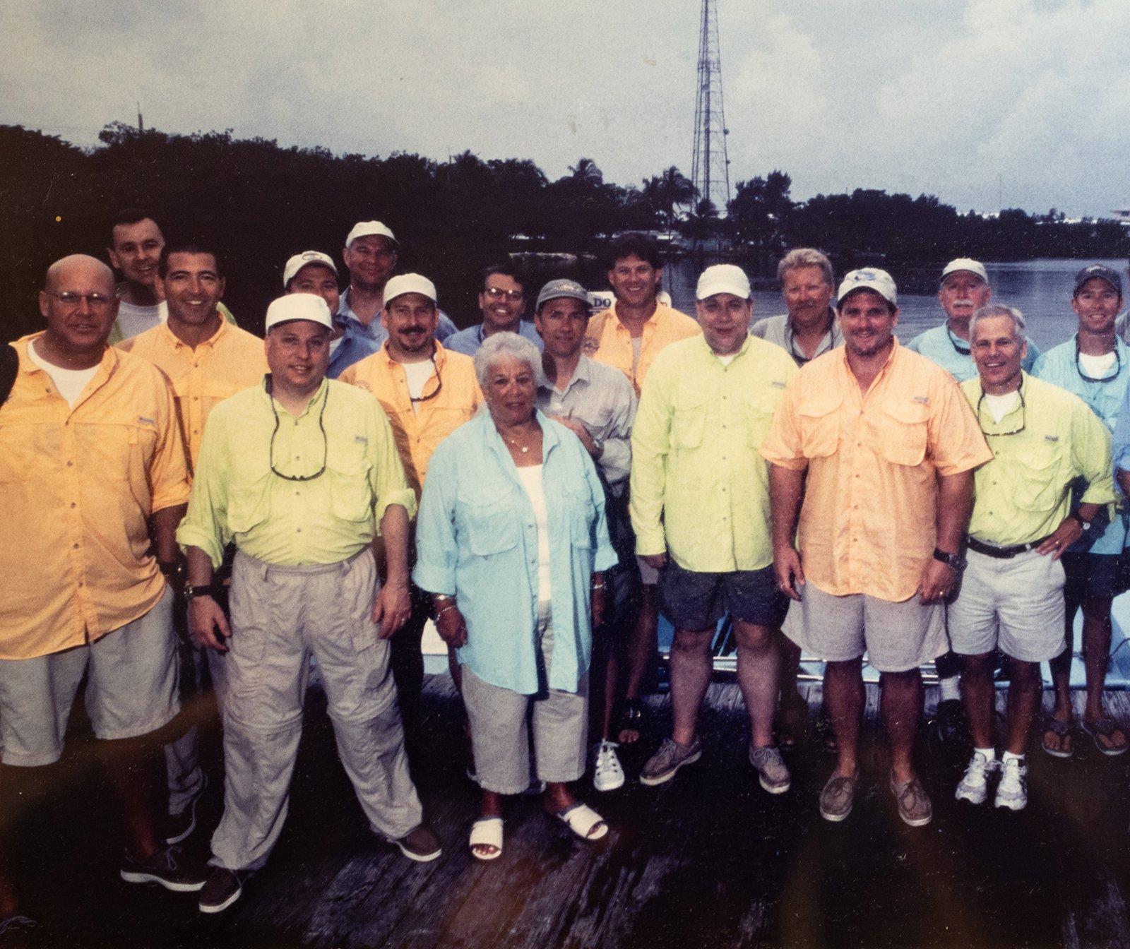 Sepia toned photo of a man wearing a Columbia fishing shirt and camo hat