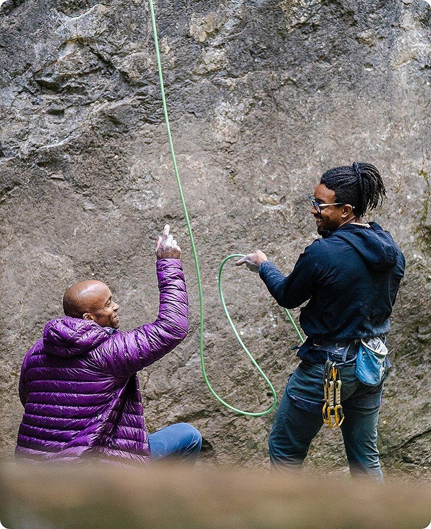 Ayo and Caleb belaying and chatting during the Open Aperture clinic