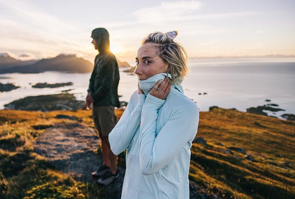 A female hiker wearing a Crater Lake Hoody takes in the moment, looking directly into the camera lense.