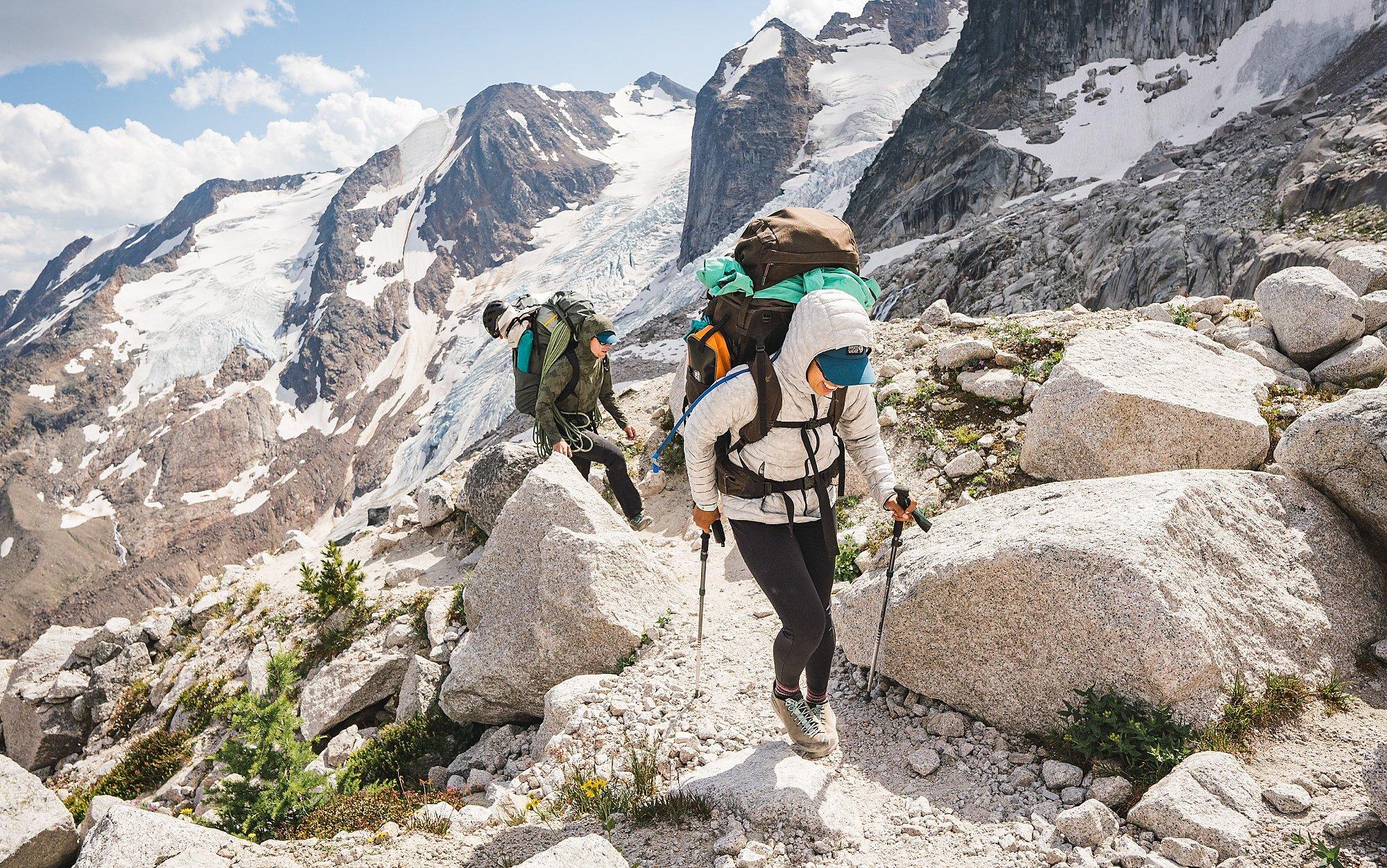 Two alpine climber backpack to their basecamp in the high country.
