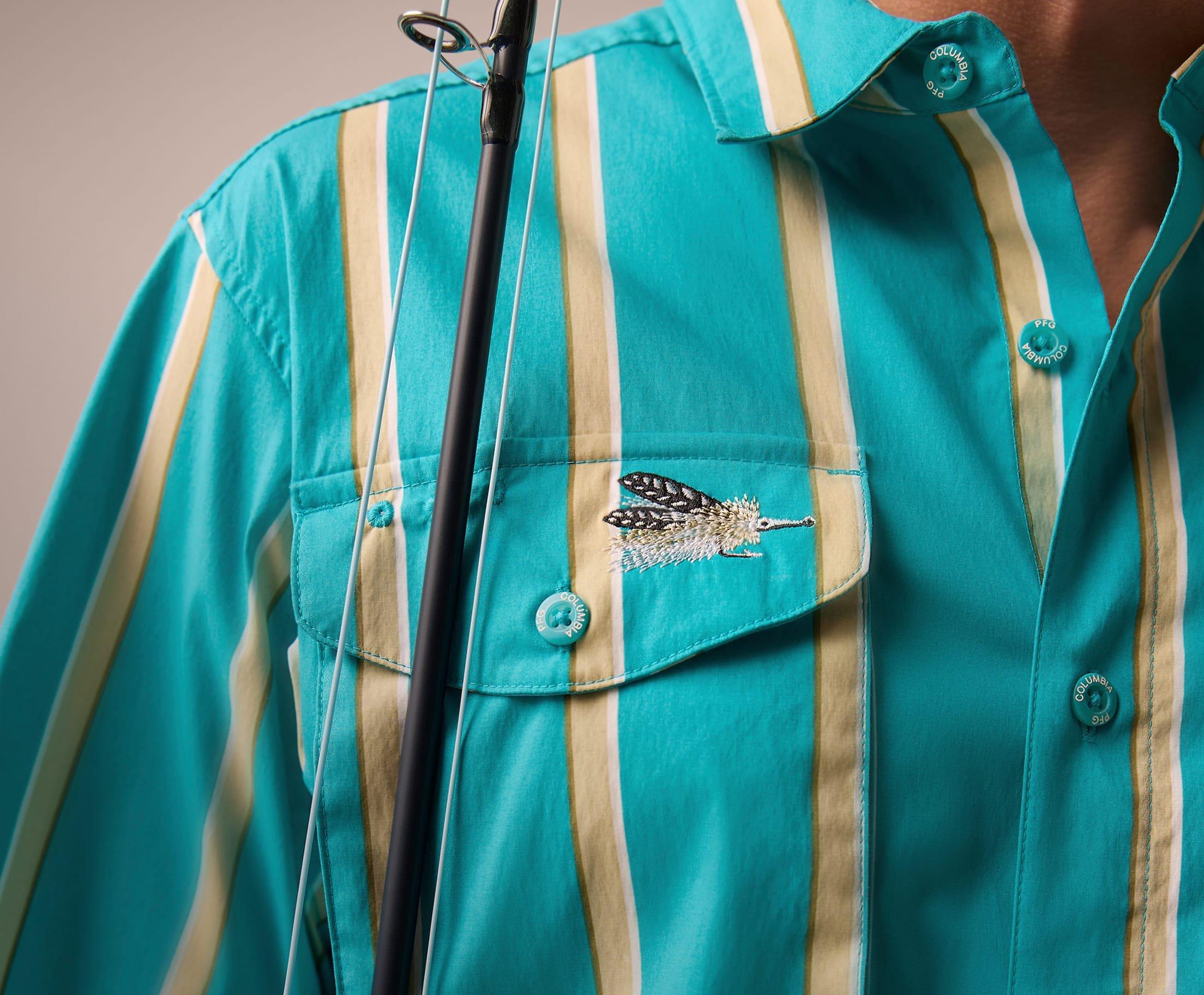 Close-up image of a blue and yellow striped shirt with fly fishing embroidery