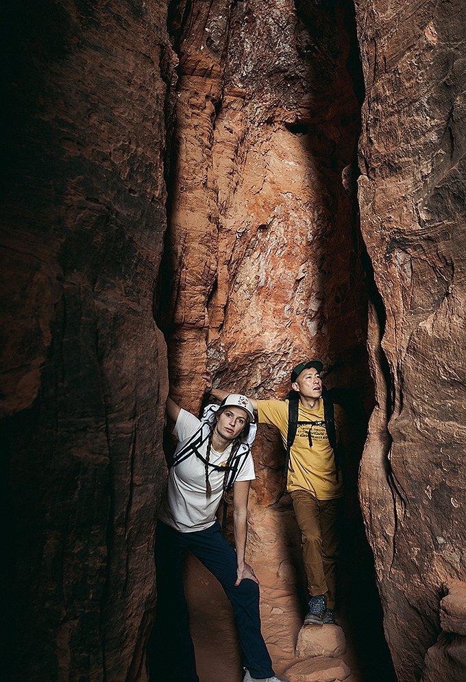 Hiking in slot canyons in the Utah desert, wearing the Women's Dynama pant and Men's Hardwear AP pant
