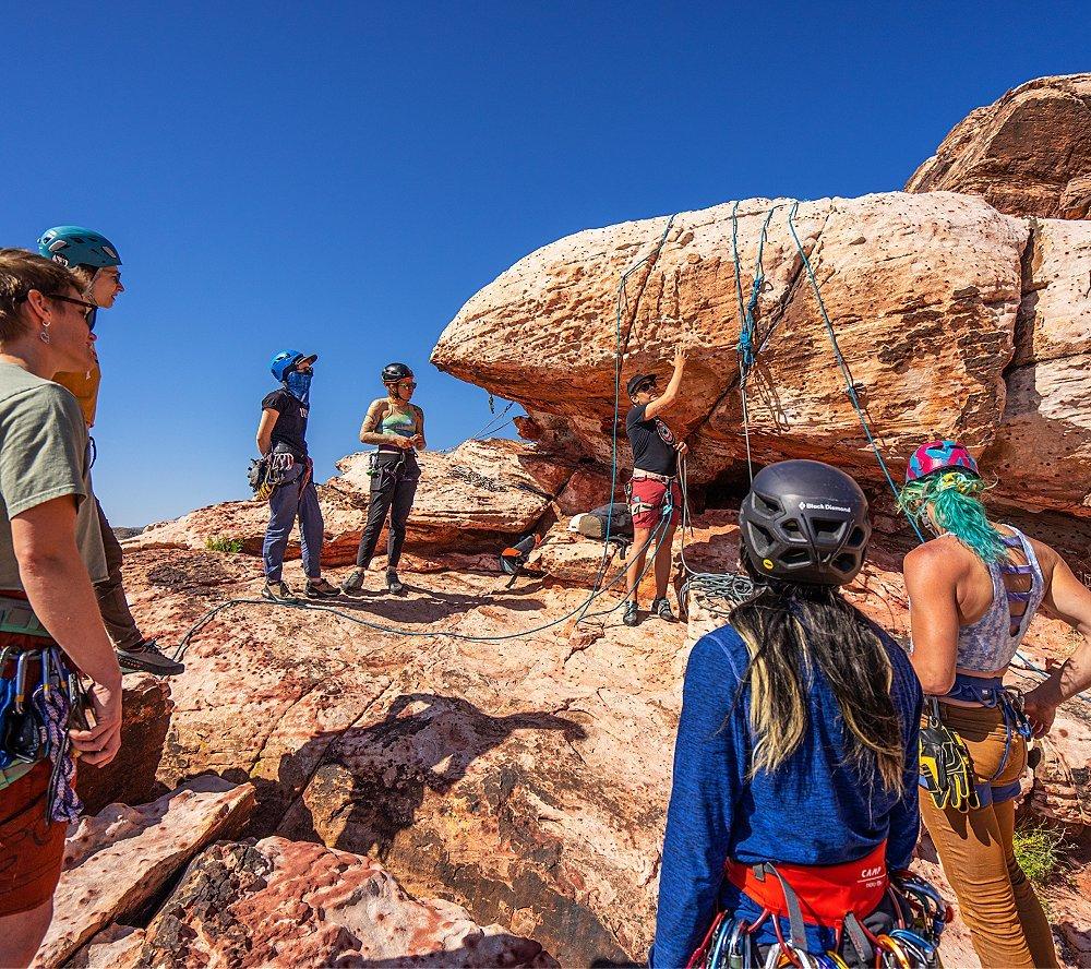 In a climbing clinic by American Alpine Club, they show the participants all the ins and outs of clipping in and creating an anchor at the top of a route.
