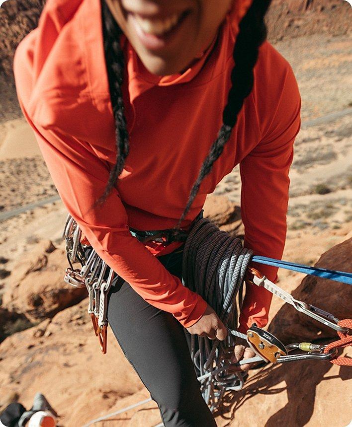 close up of Genevive smiling while at the top of a climb at the anchor