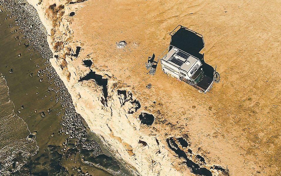 Ariel shot  of van near coast line. 