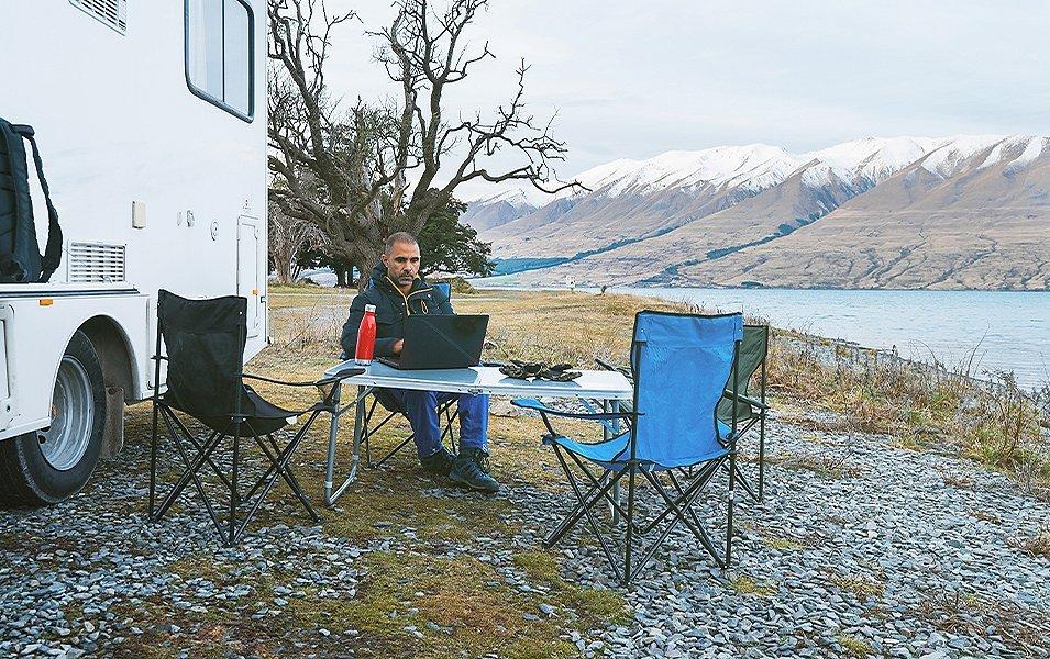 Man working outside near shoreline. 