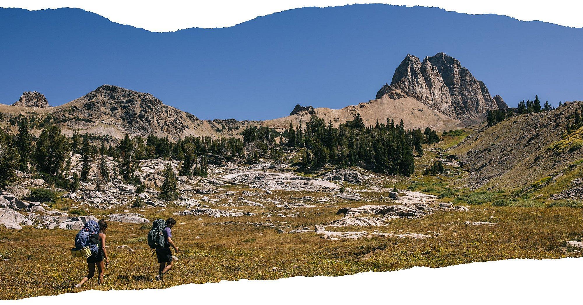two backpackers hike in the high country