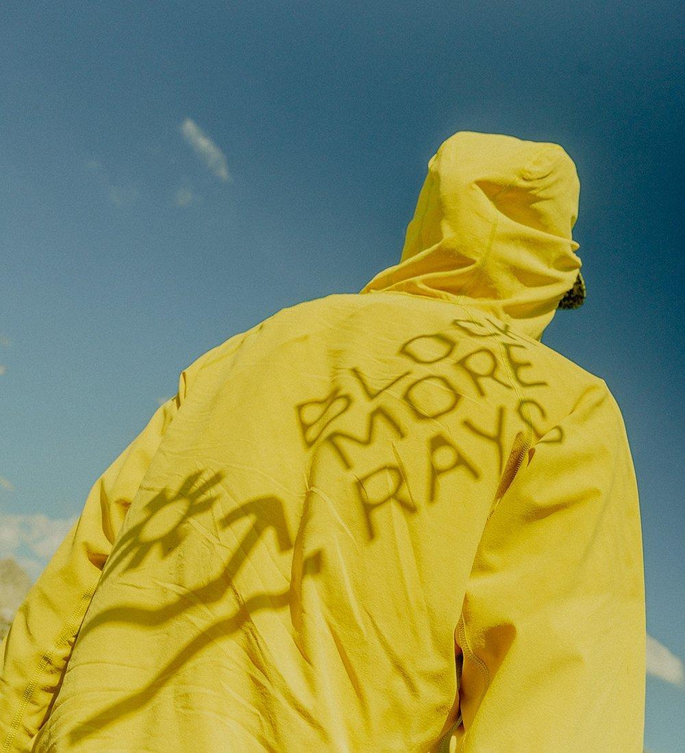 Block More Rays shadow type over a Sunshield hoody with a blue sky background.