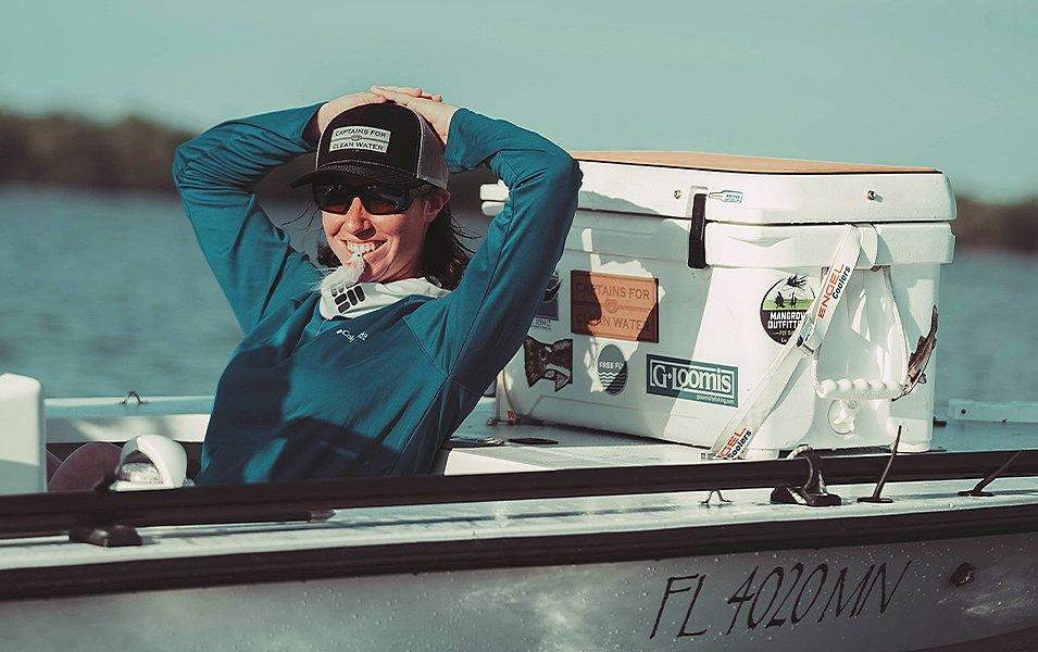 Pro angler Wesley Locke relaxes on a boat in the Florida Everglades and smiles. 