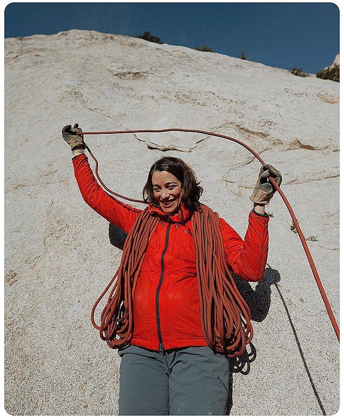 Miranda coiling a rope with a big belly and smile