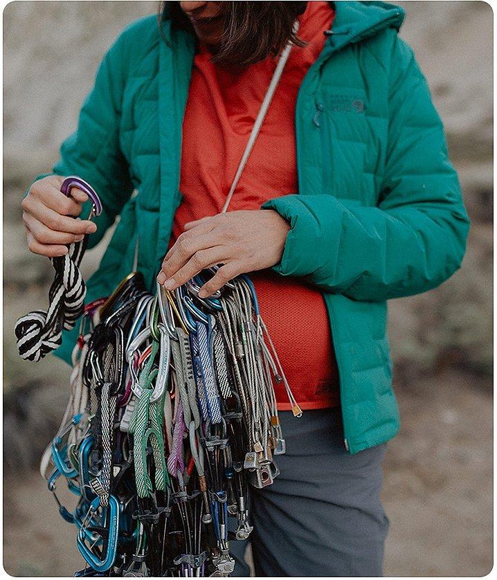 close up of a sling of climbing carabiners and Miranda's belly