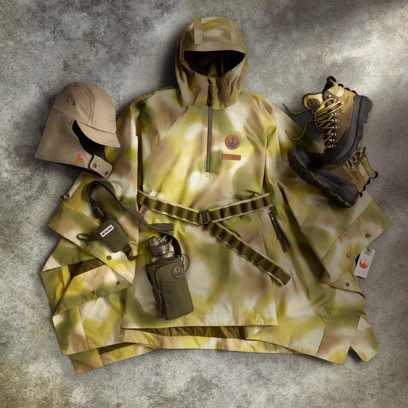 Olive and tan camouflage outfit with matching hoodie, pants, cap, boots, belt, and accessories laid flat.