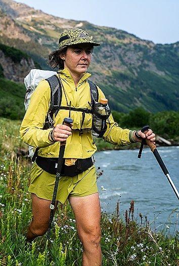 Hannah hiking in a meadow.