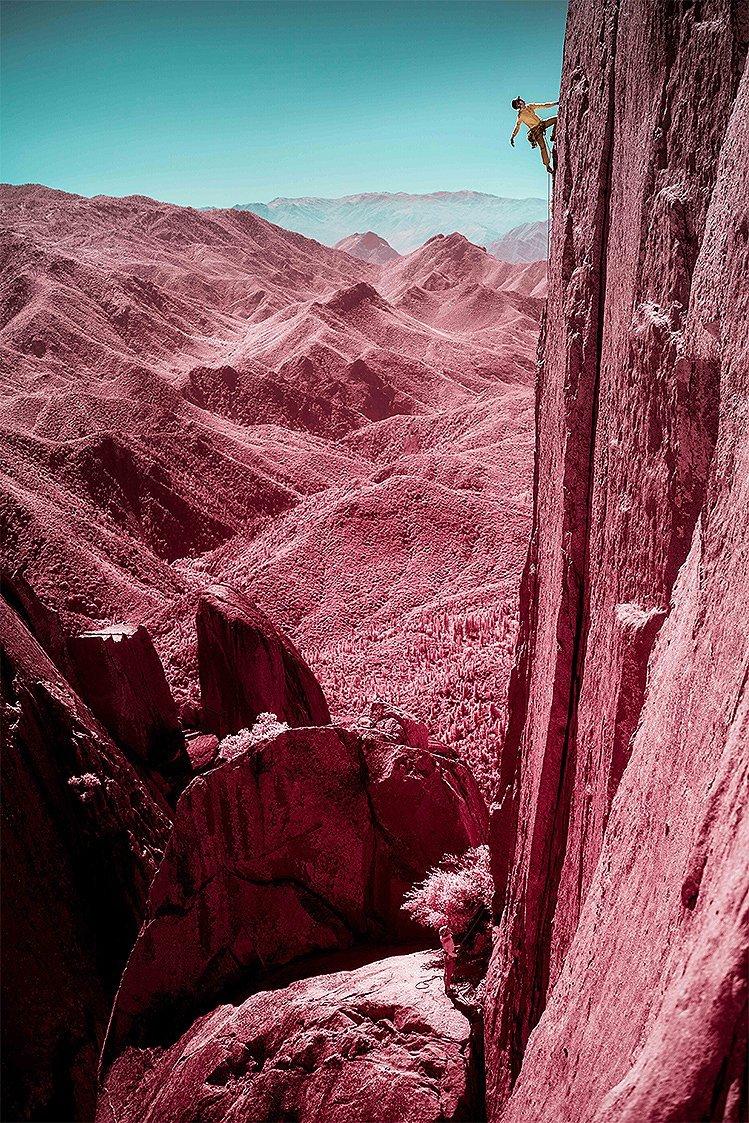 Infrared image of MHW athlete Miranda Oakley looking up for her next move, close to the top of a route.