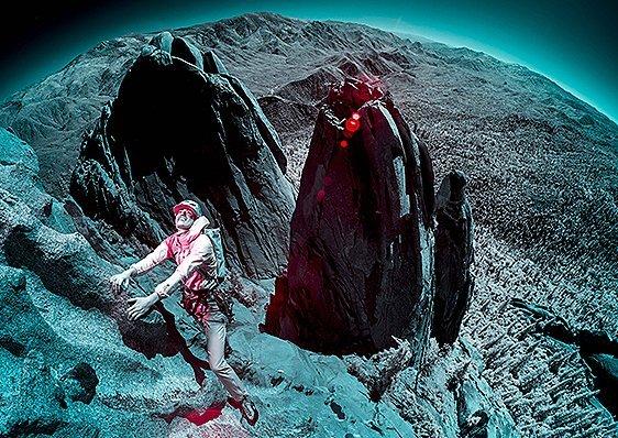 Infrared image of MHW athlete Miranda Oakley looking up for her next move, close to the top of a route.