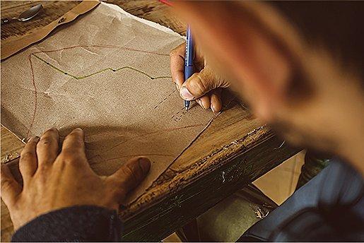 Above the shoulder, sketching out a potential line up the rock wall.
