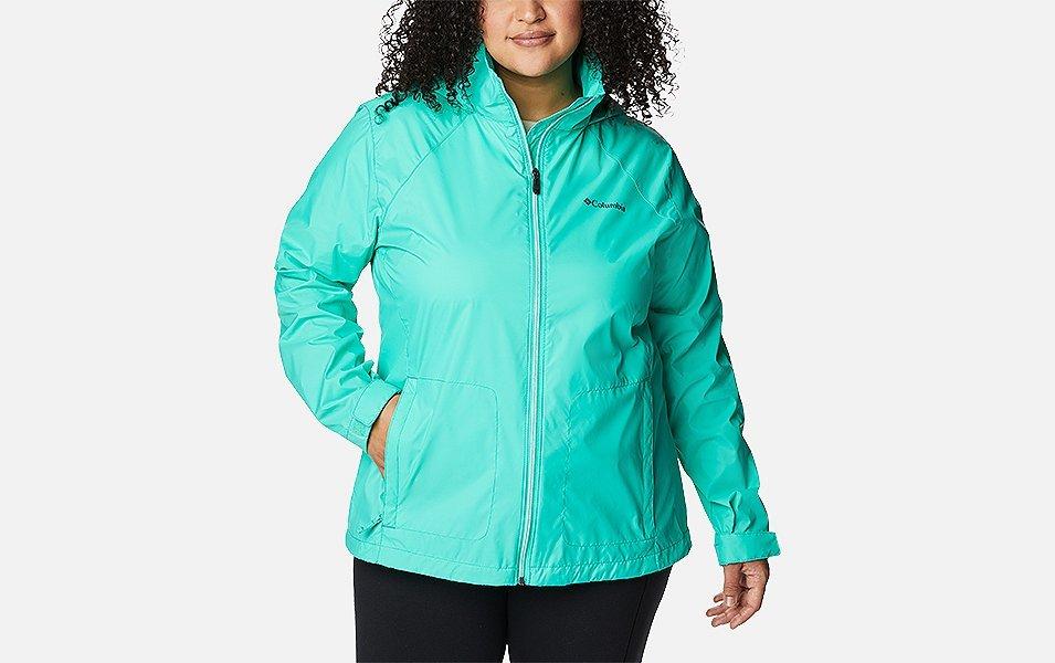 A product shot of a woman wearing a purple Columbia Sportswear Switchback III jacket with a white background.