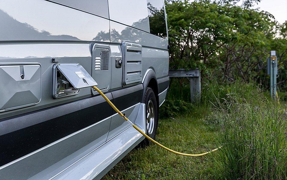 Closeup of a recreational vehicle's plugged into a charging station. 