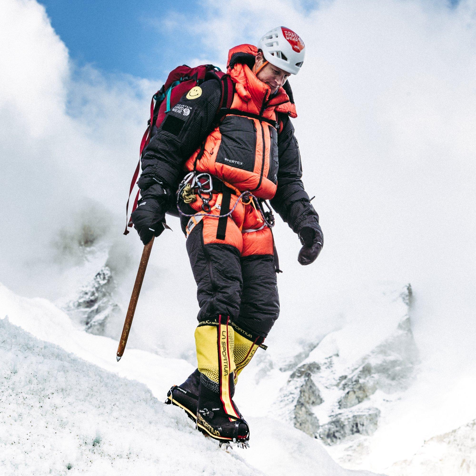 Ice axe in hand, professional mountaineer and AMGA guide Garret Madison carefully makes his way down a steep grade.