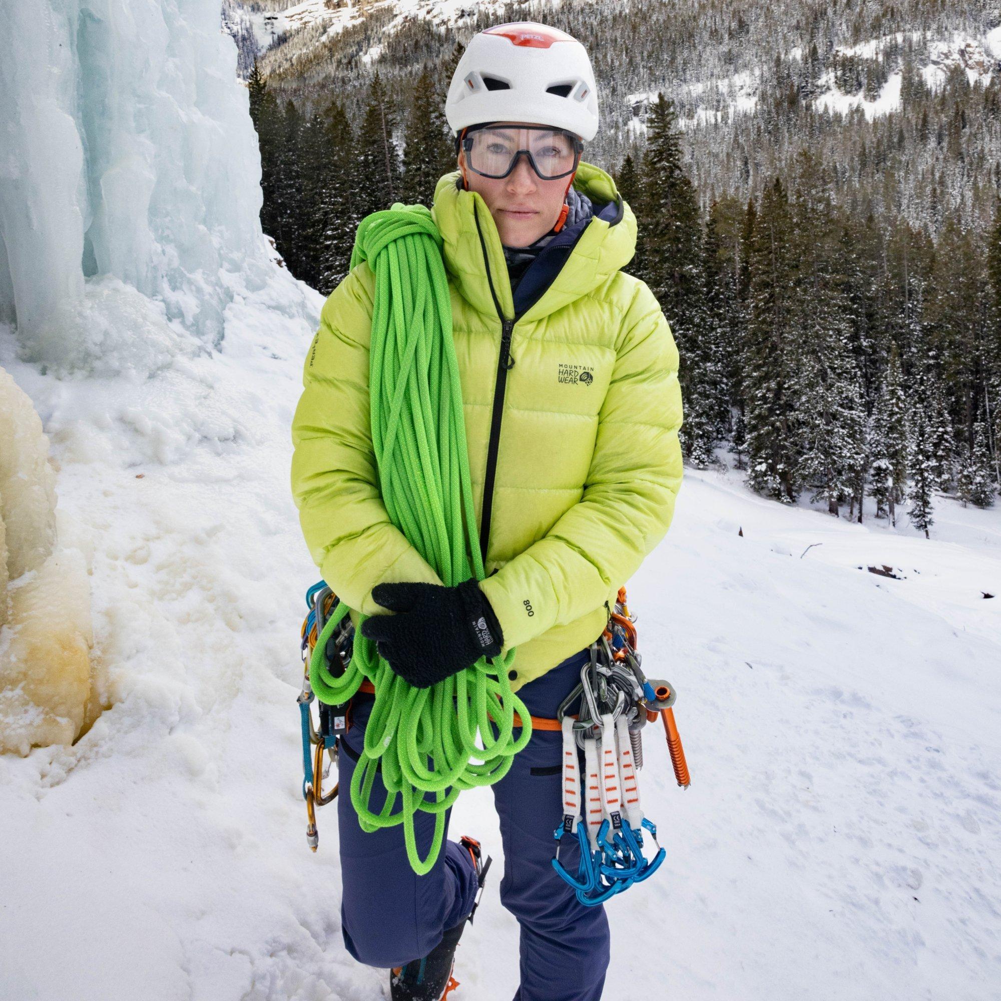 Loaded with gear and rope, professional mountaineer Kimber Cross pauses at the base.