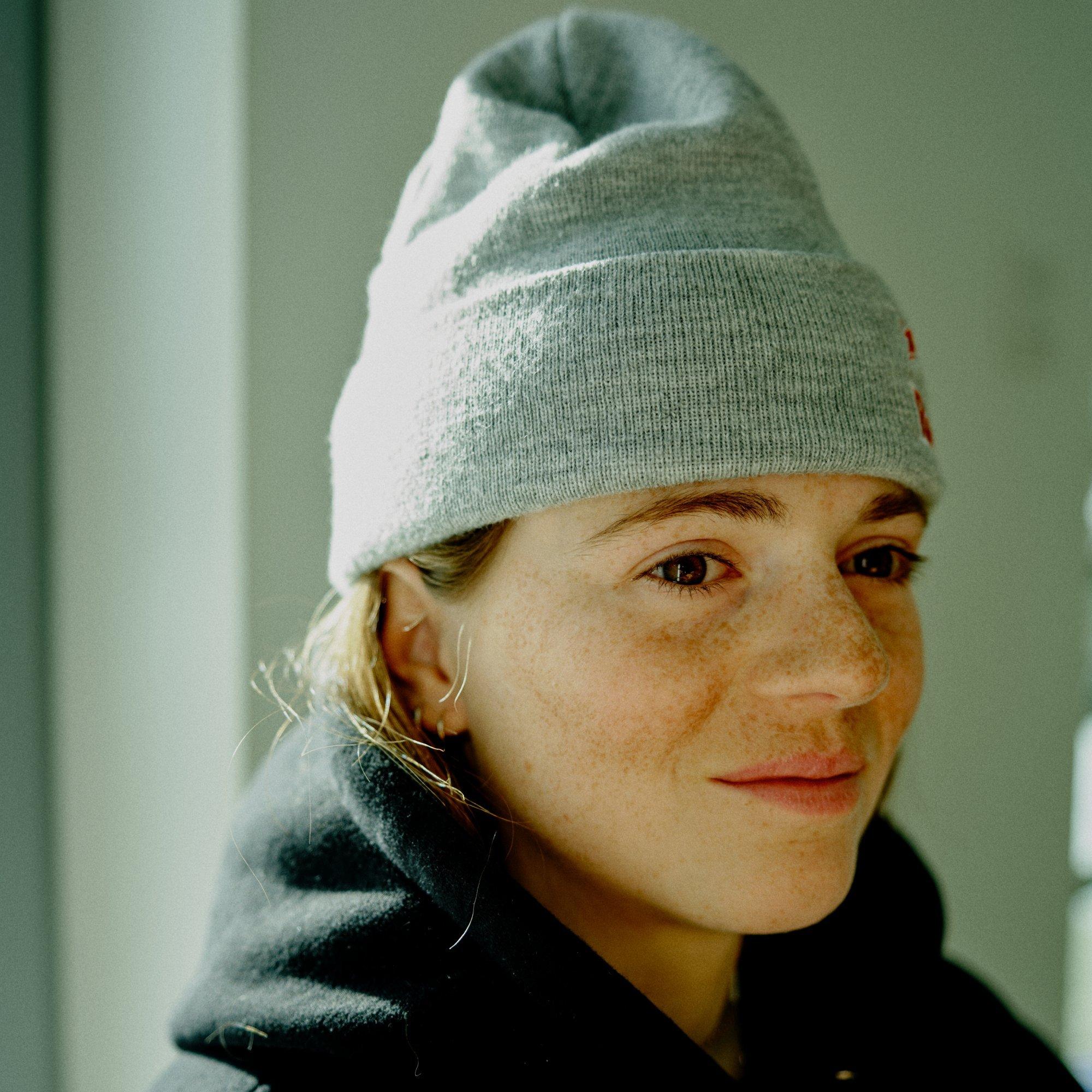 In a moment of reprieve between sessions, professional skier Manon Loschi sits in a moment of calm.