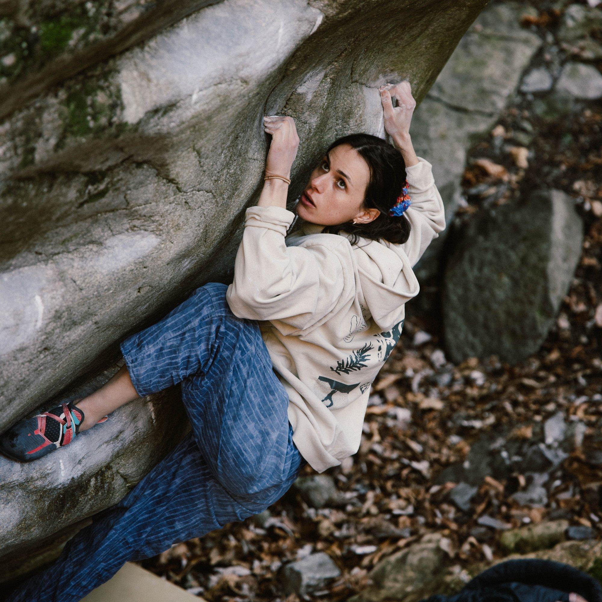 Focused on her next move, professional climber Nina Arthaud uses a heel hook to get her foot flat on the rock shelf.