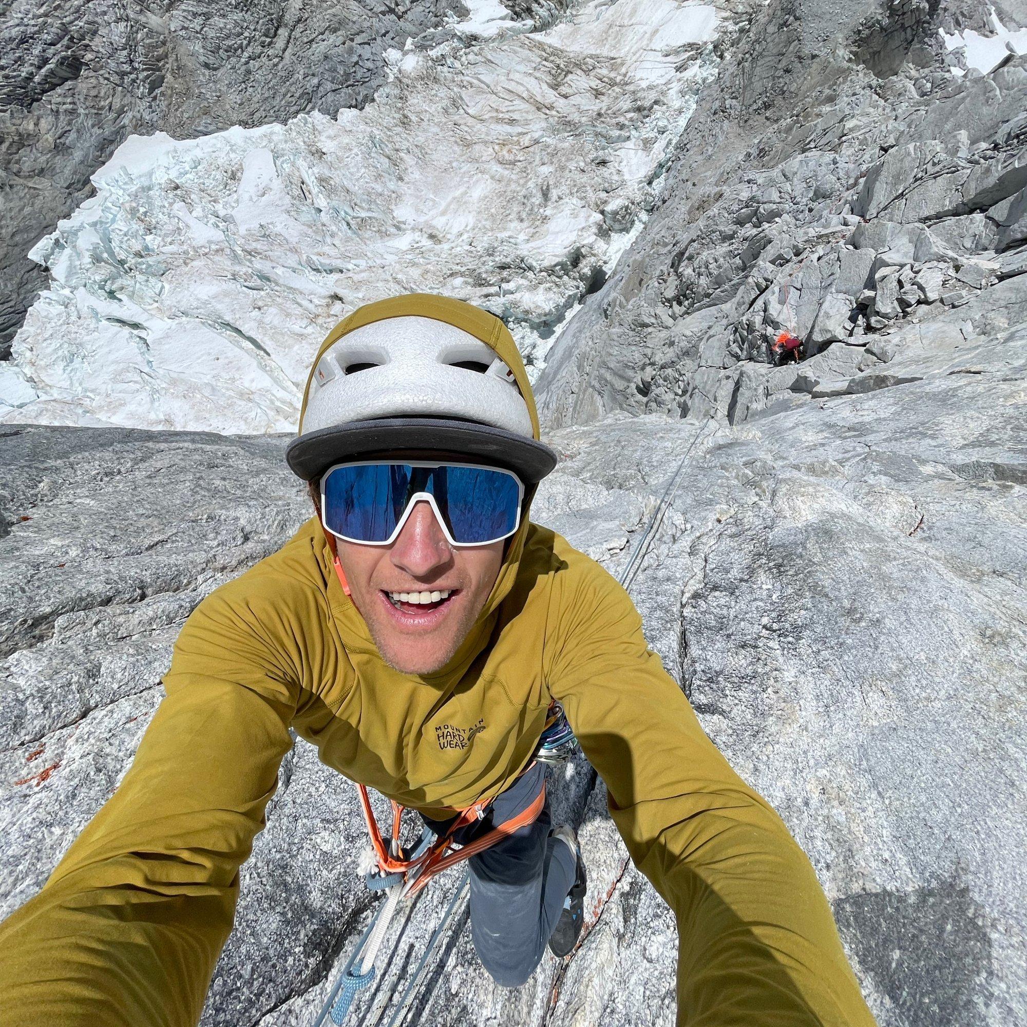 Tim takes a selfie while climbing in the high alpine.