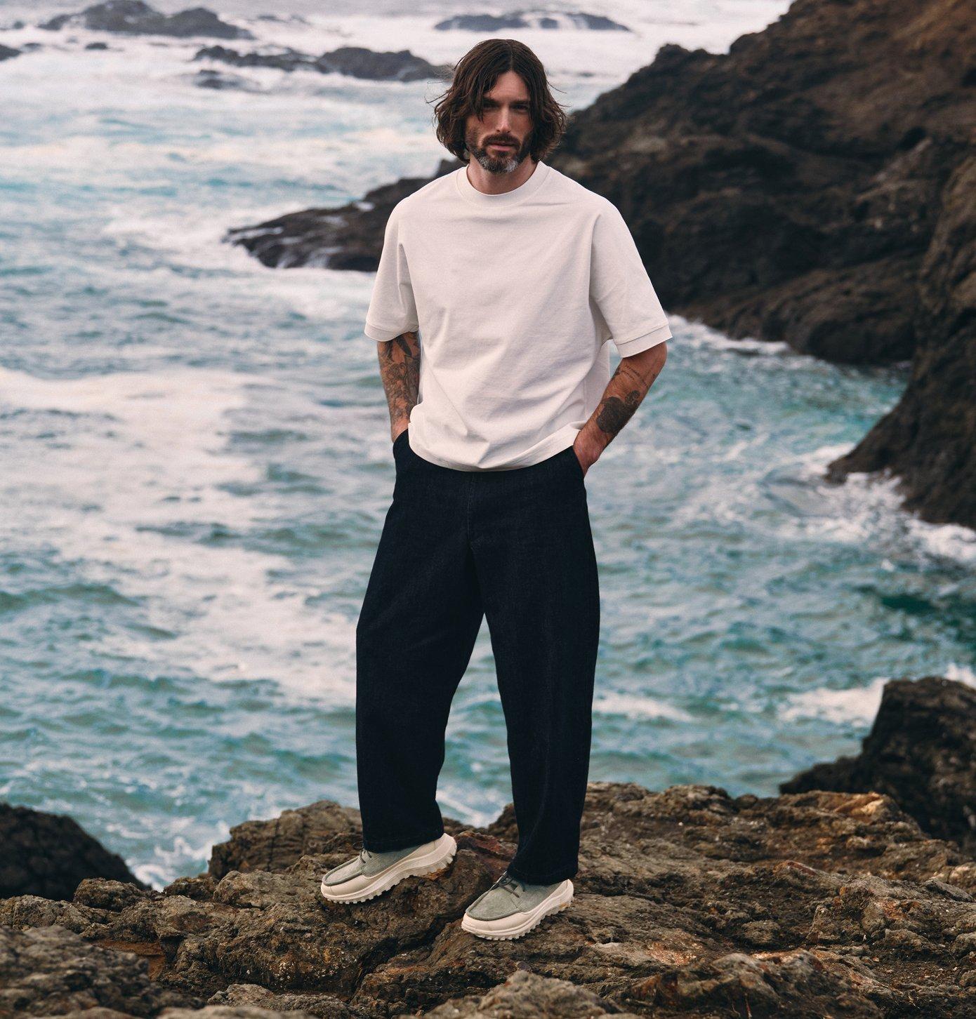 man standing by the coast wearing sorel callsign northwater shoes