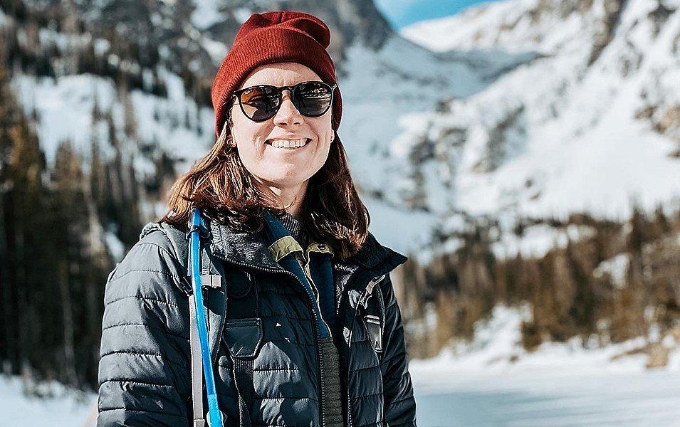Savanna Shackleford smiles at the camera with scenic mountains blurred out in the background.