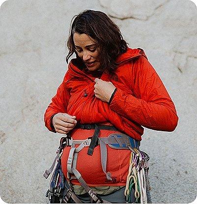 Miranda Oakley looking down at her pregnant belly