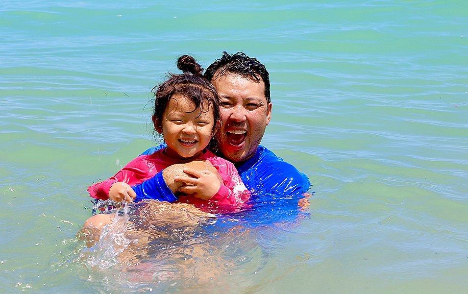 Father and daughter swimming.