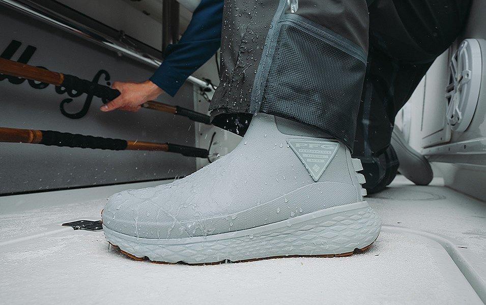 The deck is wet with rain, but an angler has secure footing, thanks to his PFG Pro Sport Boots. 