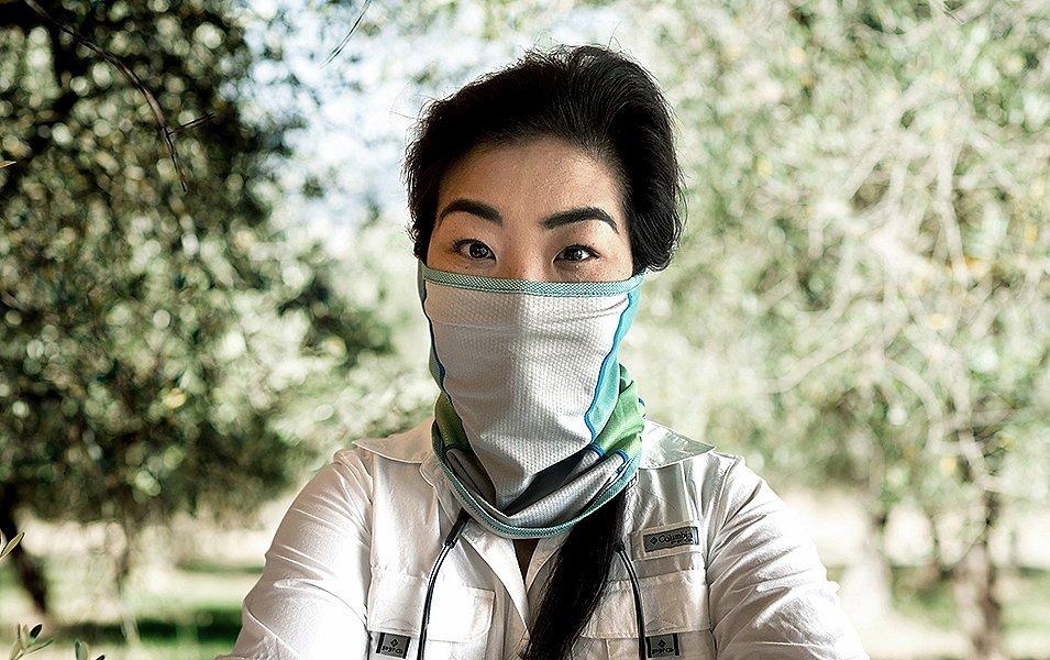 Person wearing a neck gaiter over their ears. 