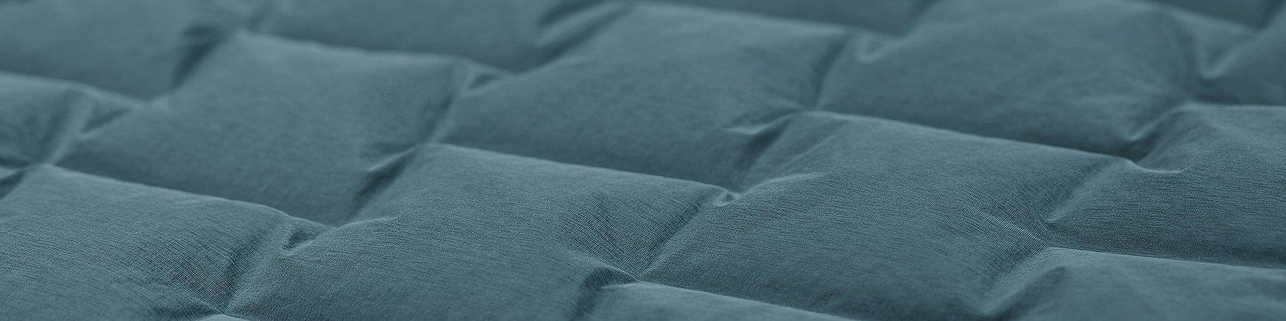 Close up macro shot of the Super/DS™ Stretchdown Hooded Jacket, zoomed in on the woven-stretch construction 