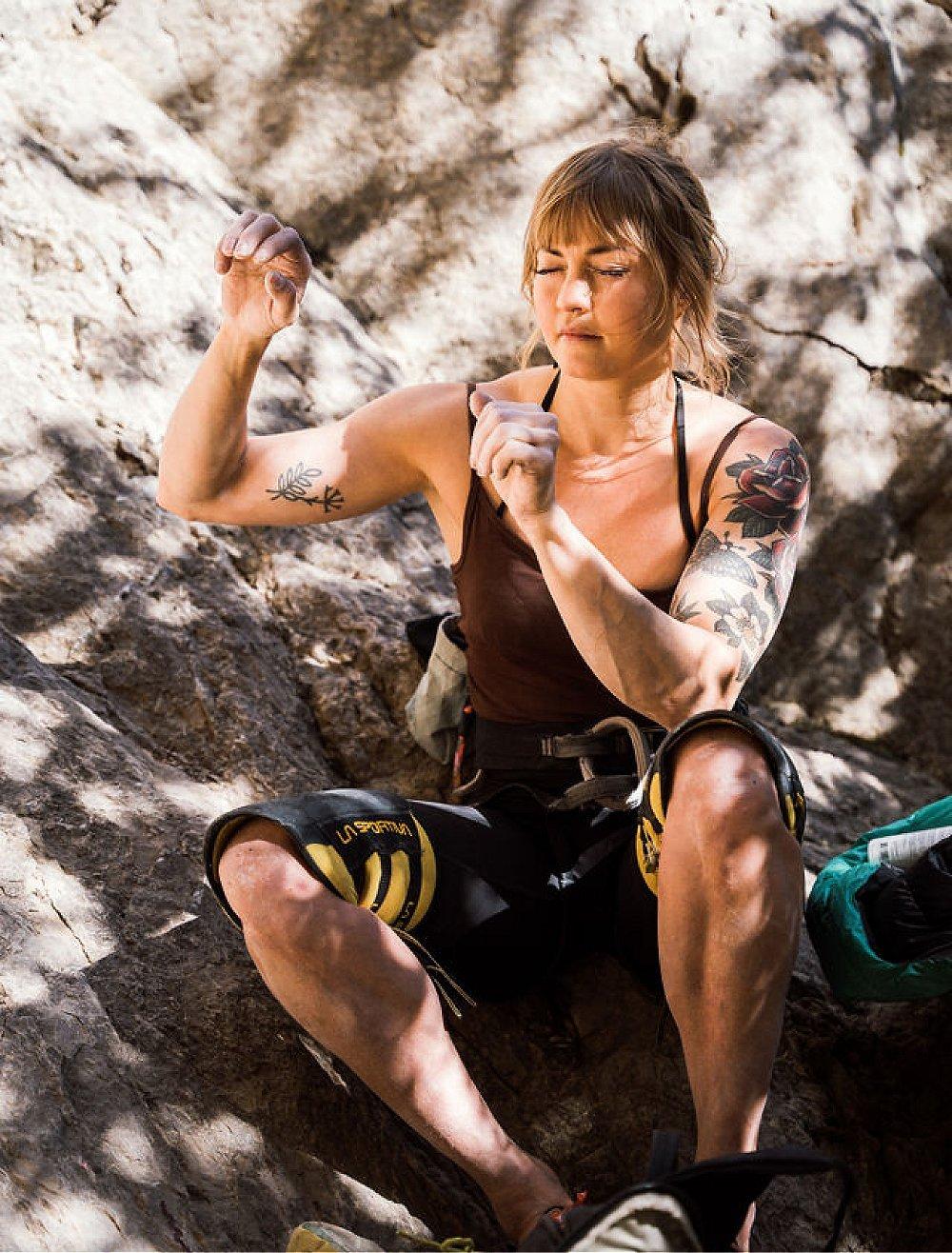 A quiet moment of Anna visualizing her hand placements for her route while sitting on the ground with her eyes closed.