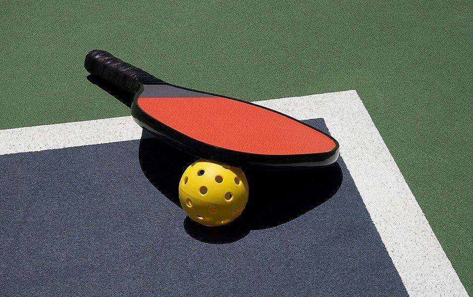 A pickleball racquet and ball.