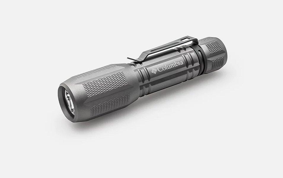 A product shot of a Columbia Sportswear hiking flashlight set against a white background.
