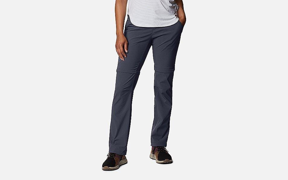 A product shot of a woman wearing navy-colored Columbia Sportswear hiking pants  set against a white background. 
