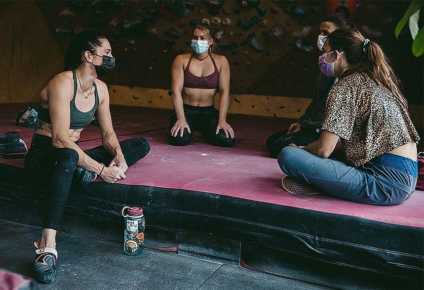 Kyra sitting with other climbers