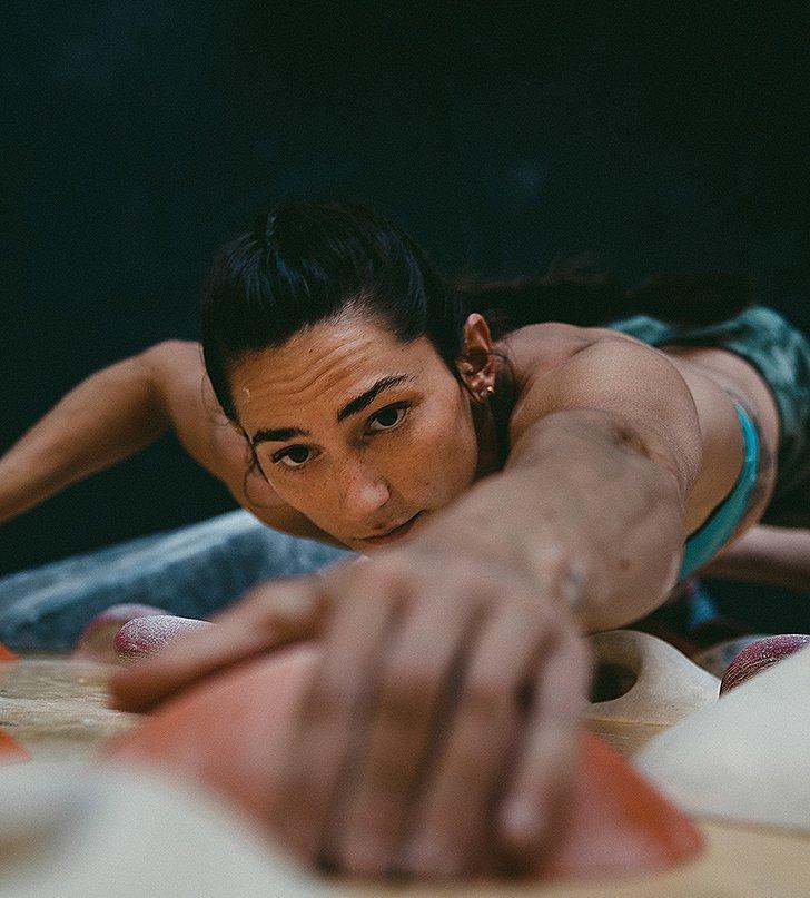 Kyra reaching for her next hold