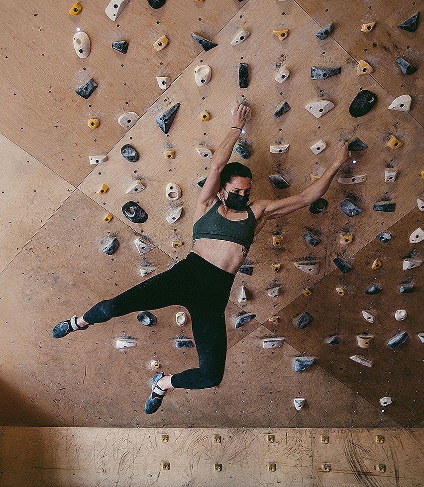 Kyra bouldering during a gym session